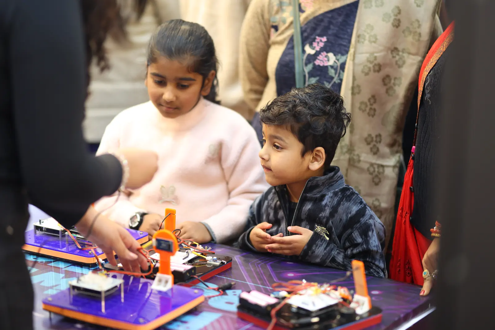 Children working through a hands-on activity at a MakerMasti learning station