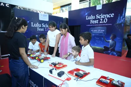 A sensors and circuits table at a science festival, with children testing motorised builds