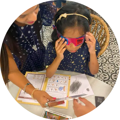 A girl in 3D spy glasses studying a fingerprint dossier at a Spy 007 party