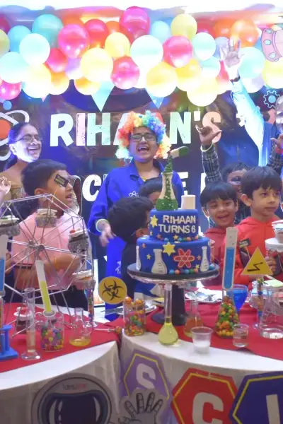 A Space Explorers birthday setup with a balloon arch, planets and a decorated table